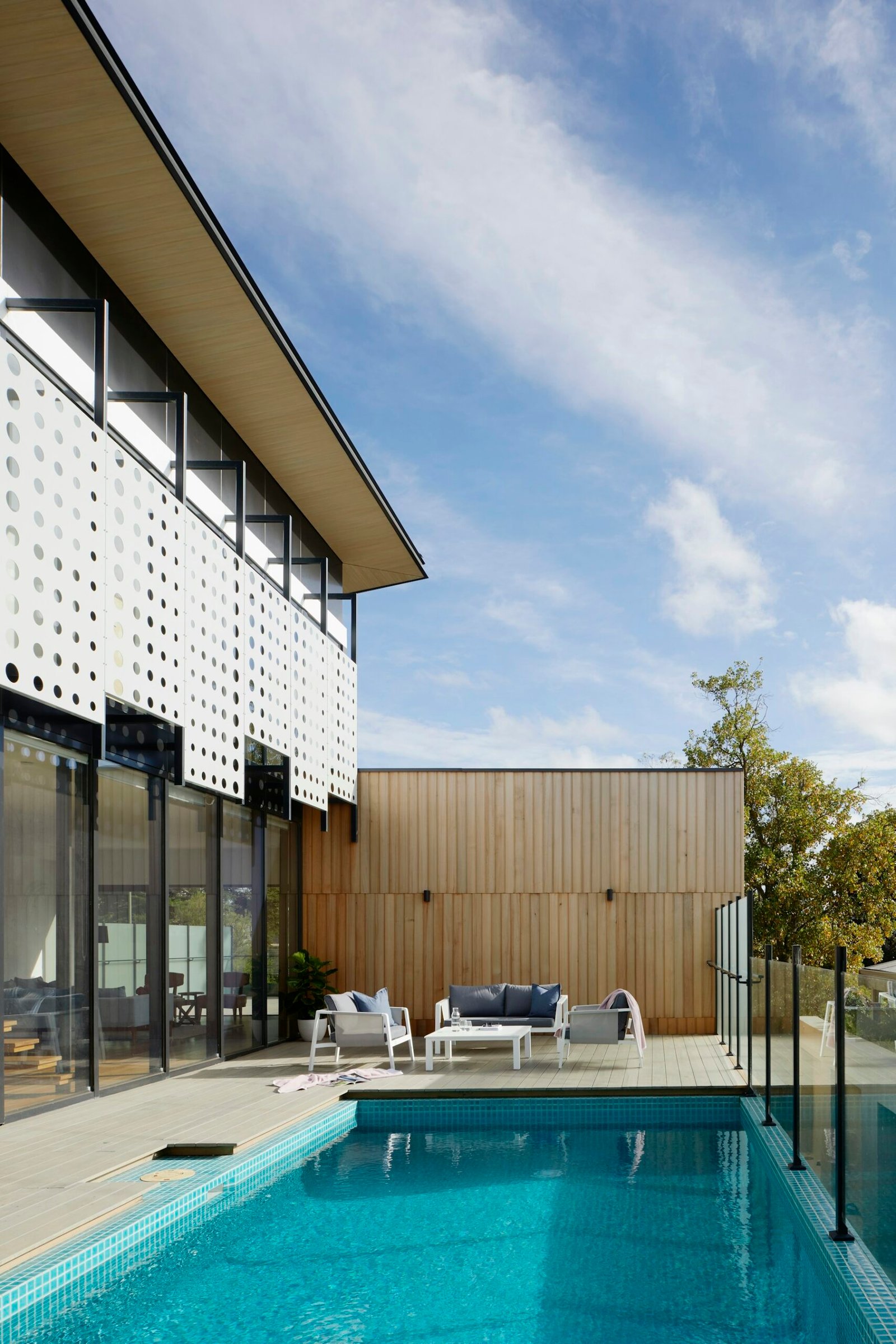 Tall glass residence among forest trees