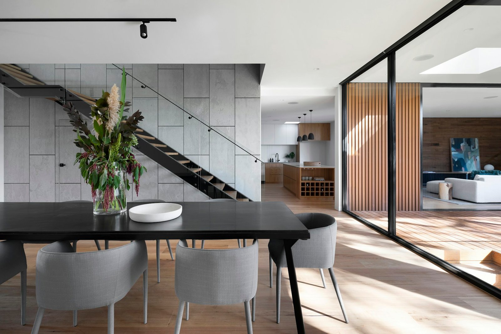 Warm contemporary interior framed by glass and dark landscape